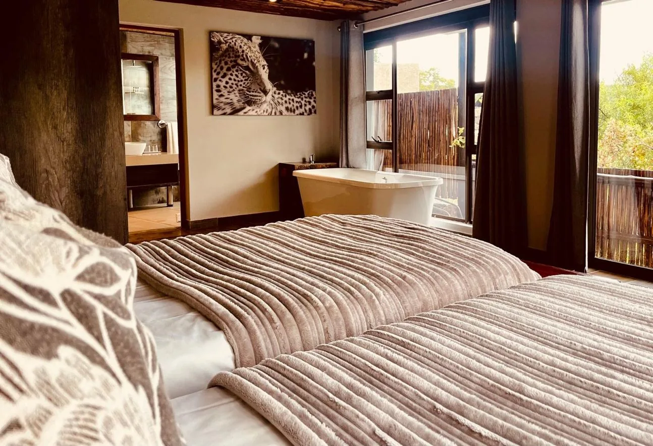 Safari lodge interior — freestanding bath with bush view