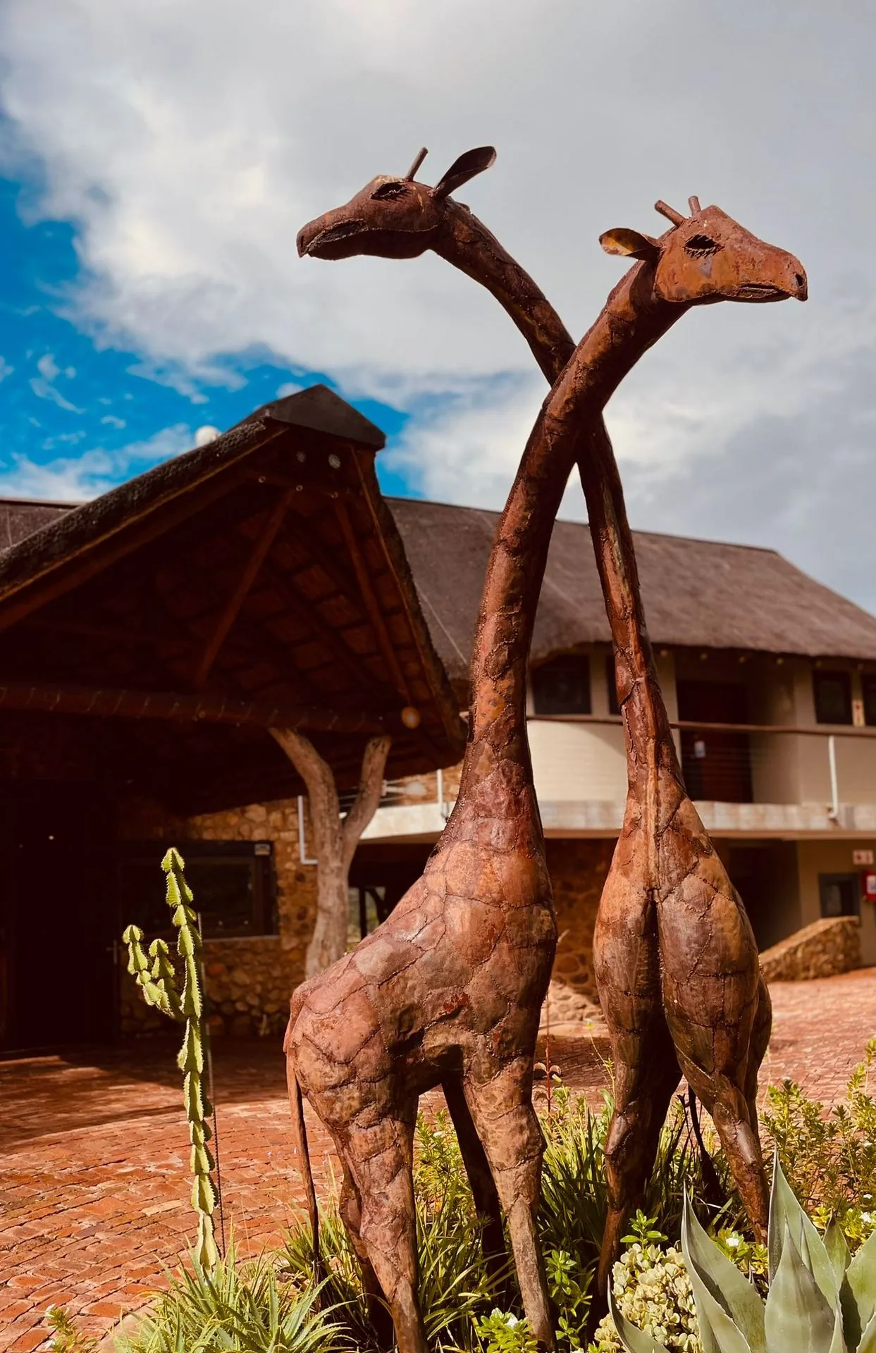 Bronze giraffe sculptures at lodge entrance